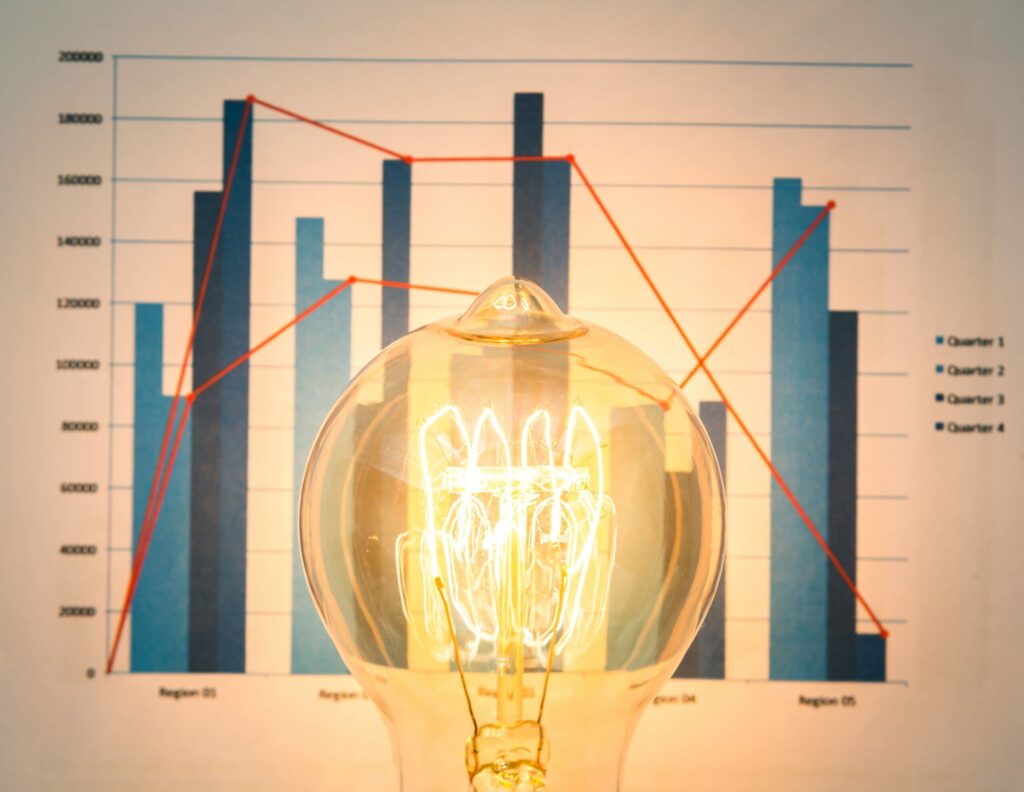 close-up-illuminated-light-bulb-with-chart-background (1)